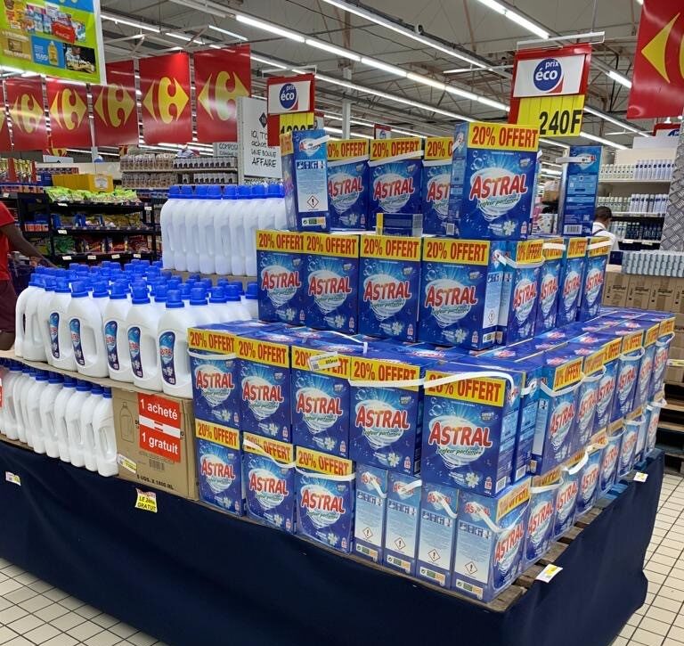 Astral laundry detergent promotional display in a supermarket, showcasing Amalthe's retail activation, consumer brand development and FMCG market execution.
