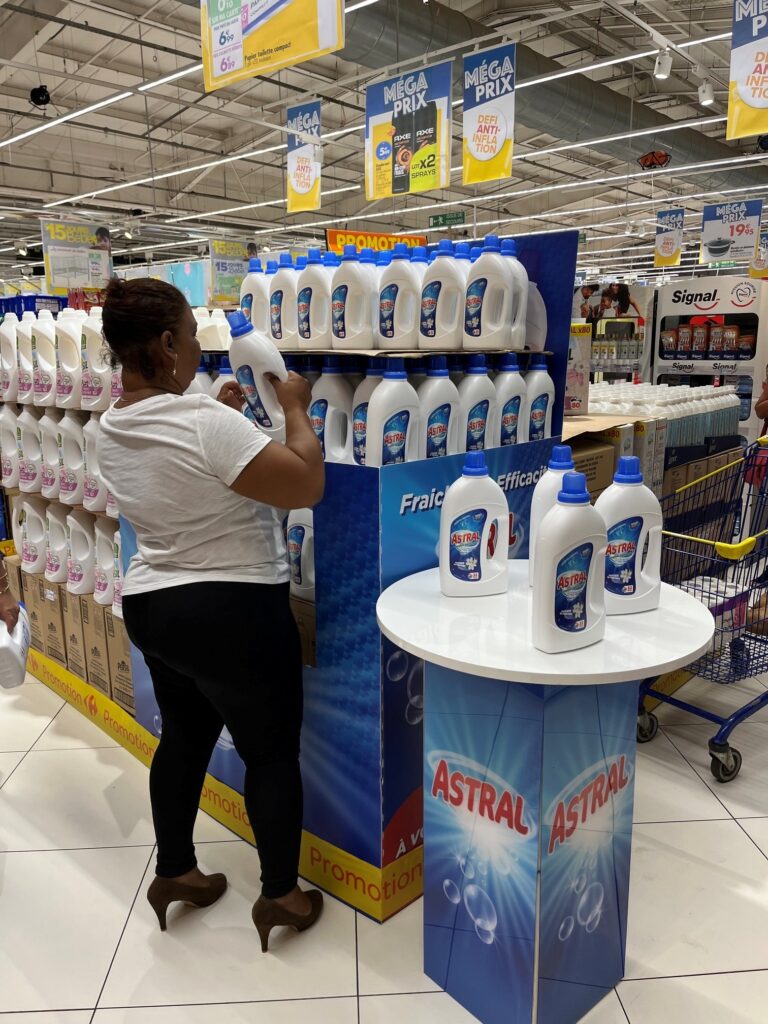Astral laundry detergent retail activation display in a supermarket environment, supporting Amalthe's laundry care brand portfolio through in-store merchandising and consumer engagement.